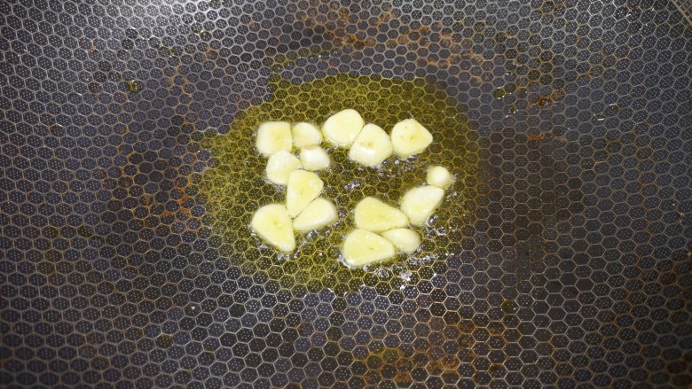 番茄炒鱼片,炒锅内倒适量的食用油烧热,下入蒜片炒香。