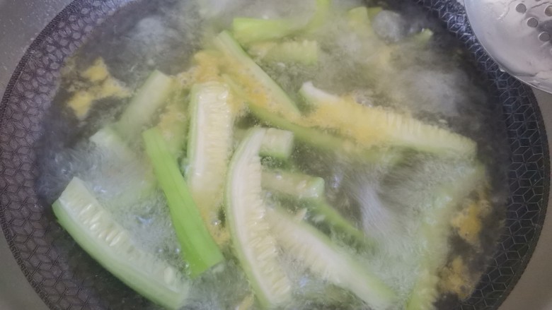 凉拌丝瓜,锅里烧水加入适量的盐,油,水开下入丝瓜焯水至断生