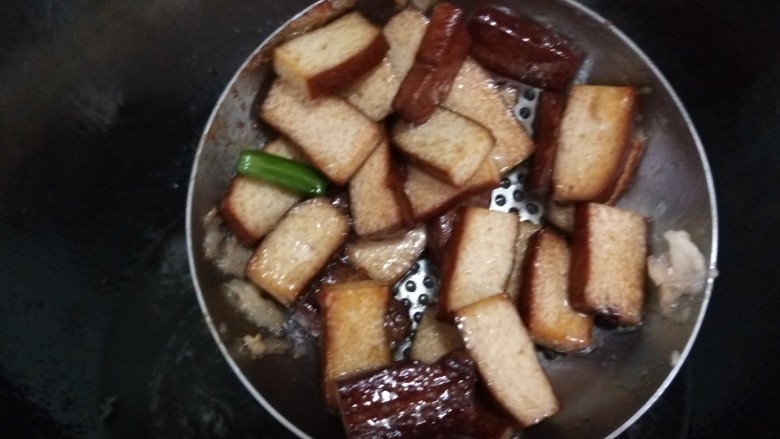 蒜苔香干,过一下油捞出来,肉片过油捞出来。