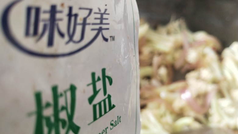 椒盐花菜,倒入椒盐,炒匀,倒一点开水炒,加点酱油,翻炒片刻
