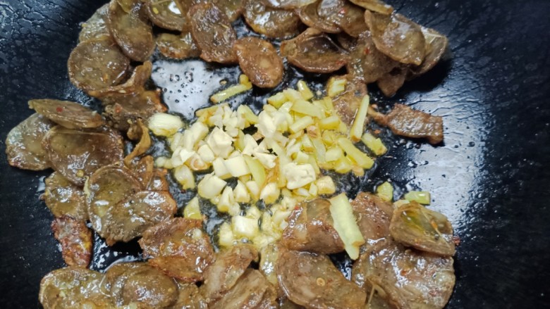 豆米炒腊肠,加入生姜大蒜,翻炒