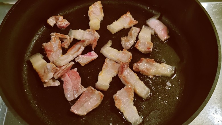 土豆回锅肉,锅中放入1汤匙食用油加热,放入肉片煎至两面微微焦黄色出锅。