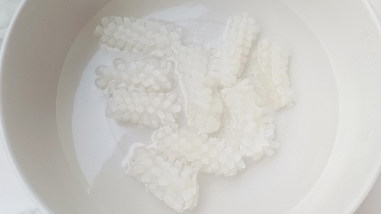 双椒炒鱿鱼花,锅中烧开水,加一勺料酒,3片姜,放入鱿鱼煮30秒捞出备用。