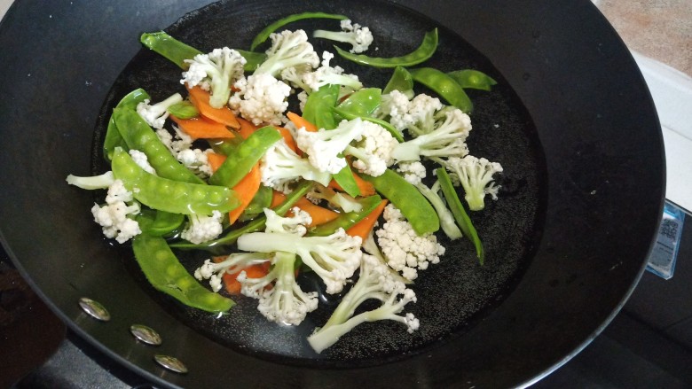 荷兰豆炒花菜,锅中烧水加入胡萝卜,<a style='color:red;display:inline-block;' href='/shicai/ 2629'>花菜</a>,荷兰豆焯水,捞出备用
