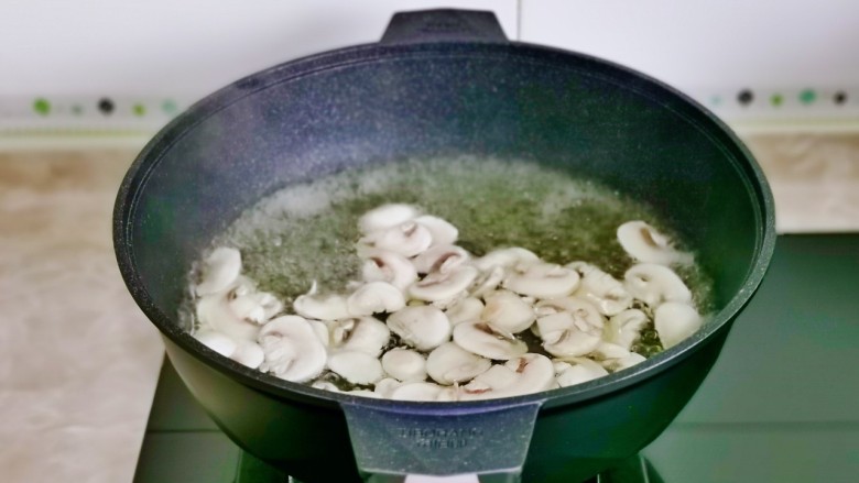杏鲍菇炒虾仁,杏鲍菇,口蘑下锅煮2分钟捞出。