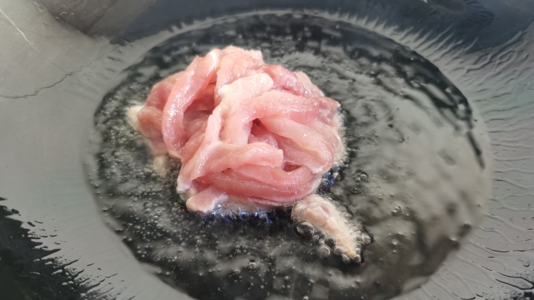 辣椒豆腐干小炒肉,炒锅烧热放油,放入肉丝。
