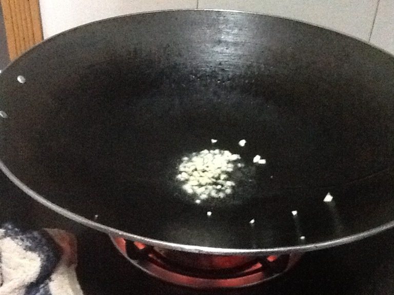 黄豆酱香肠炒饭,将油和姜末倒入锅中，开火等油热起来。