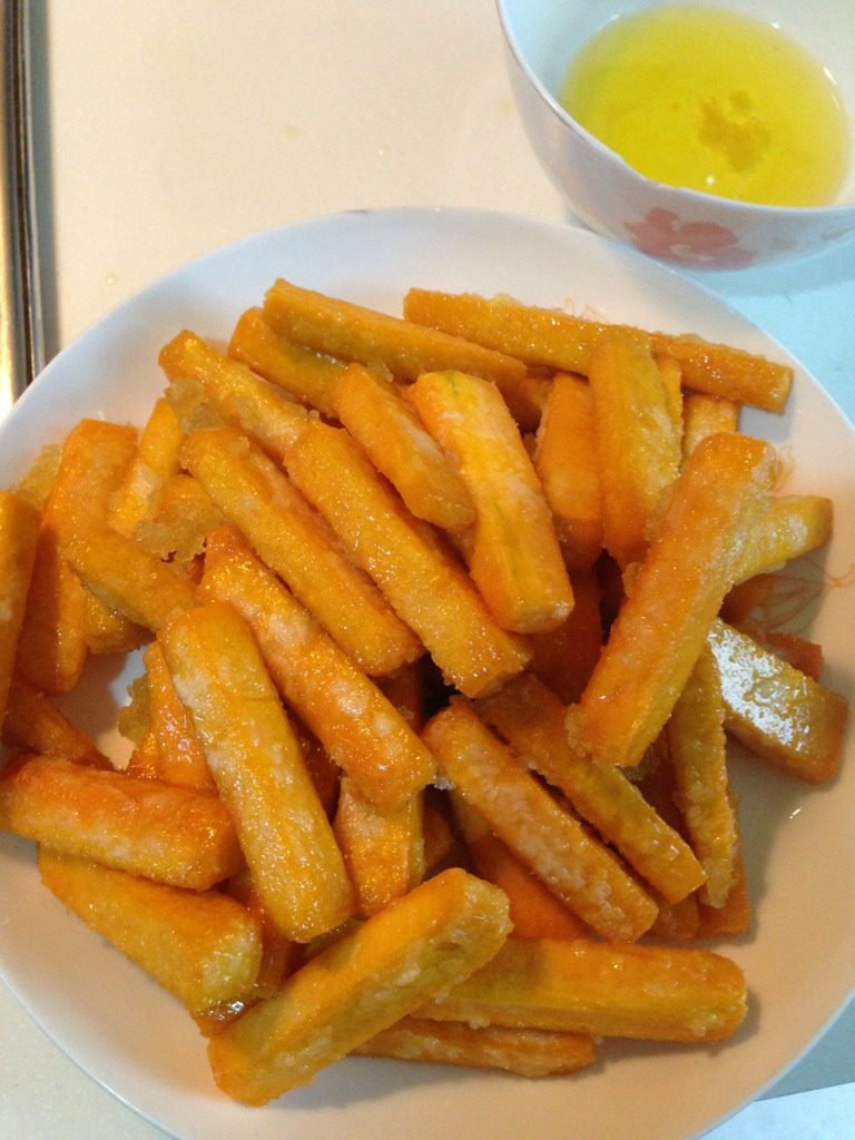 咸蛋黄焗南瓜,把南瓜段慢炸至变硬,颜色呈浅黄后,沥干油取出备用。把油里的淀粉渣滗出去,油还可以接着用