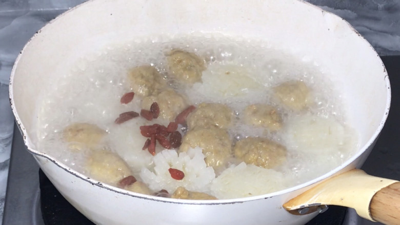 菊花萝卜丸子汤,15分钟后打开锅盖,放入枸杞,拌匀