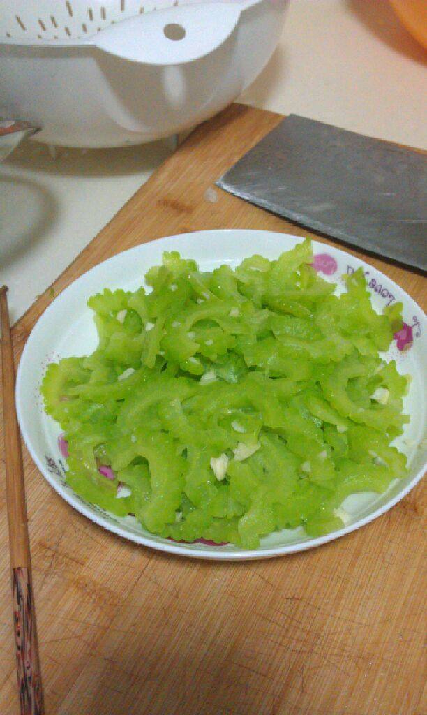 凉拌苦瓜,3.拍两蒜瓣，撒上盐与苦瓜一起拌匀，盖上保鲜膜放入冰箱的冷冻室20分钟，取出来拌上<a style='color:red;display:inline-block;' href='/shicai/ 847'>香油</a>就可以了！