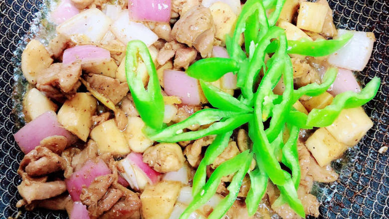 杏鲍菇炒鸡丁,放入尖椒丝,翻炒入味。