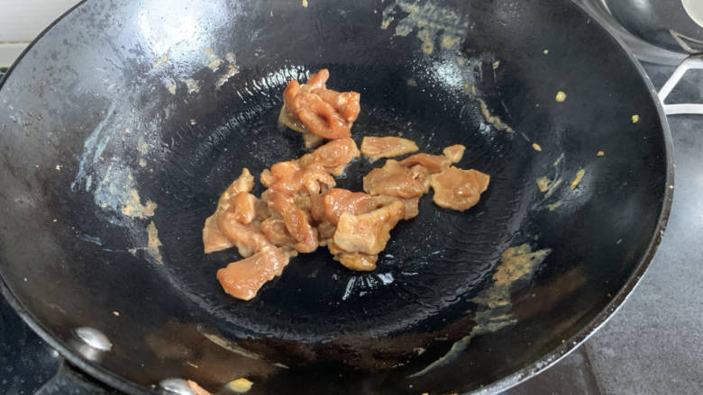 蒜苔炒肉片,热锅倒油,下入肉片煸炒