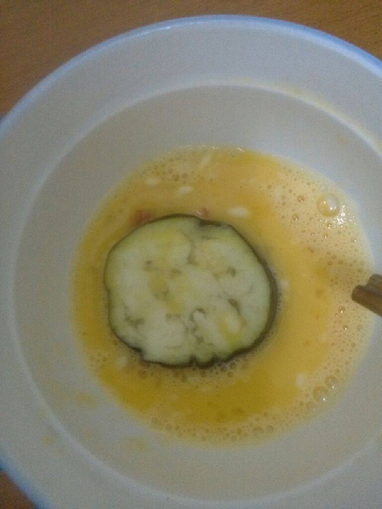 胡萝卜茄饼,把蒸软的茄子放鸡蛋液里晃几下,让鸡蛋液沾在茄子上,尤其是沾在茄子开缝的那一边