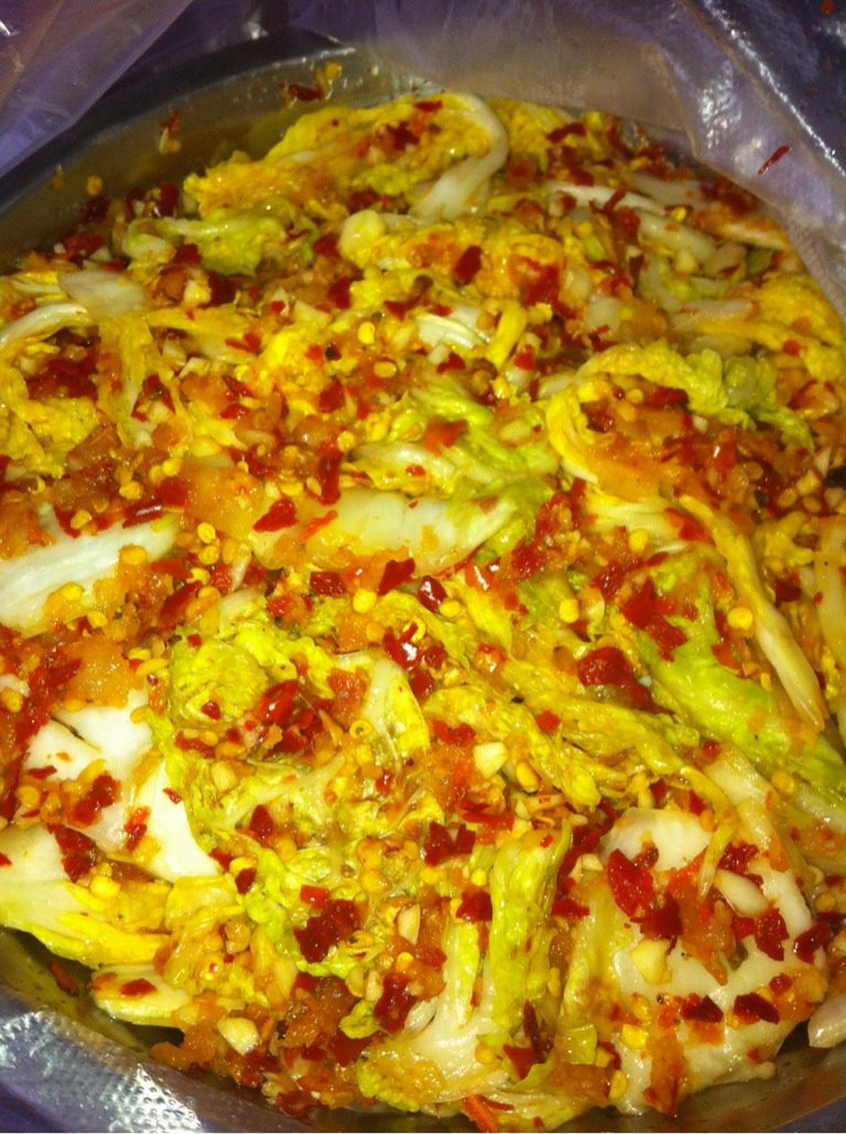 简单版自制辣白菜,如图沙水后的白菜用腌料拌匀,使白菜的每一处都粘有腌料,(因朋友给我带错了辣椒粉、所以只能用这个)