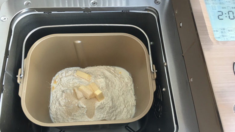 菠萝小面包,将面团材料全部放入面包机内,使用标准面包菜单进行揉面。