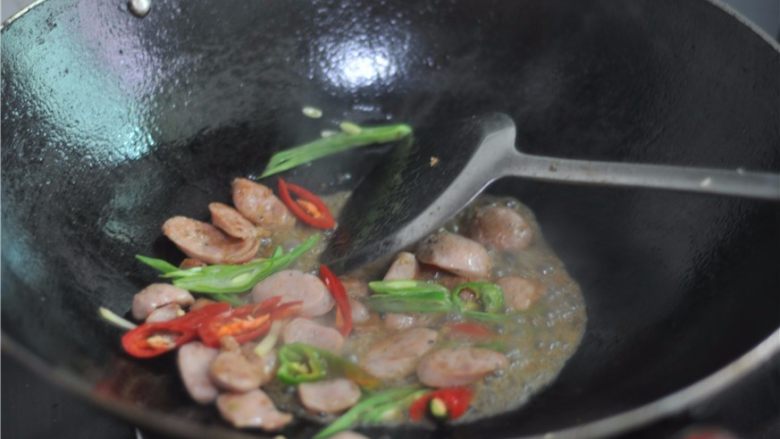 四季豆炒肉肠,稍微烧制片刻，撒入少许盐，翻炒均匀