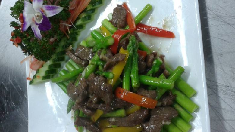芦笋绘牛柳,牛肉用热油浸至九成熟后加配料和乘下3份之l的芦笋一起去炒,炒好放在灼熟的芦笋上面就可以了