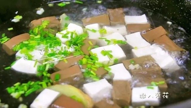 鸭血豆腐汤,水开后放入豆腐和鸭血,加葱叶,煮开后中小火炖3分钟。