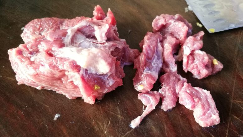 酸豆角炒牛肉末,牛肉放案板上先切片。