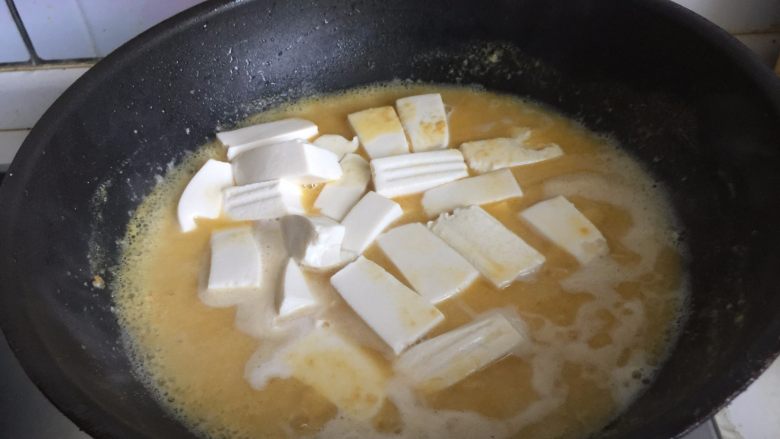 咸蛋黄虾仁豆腐,倒入豆腐块,煮5分钟左右