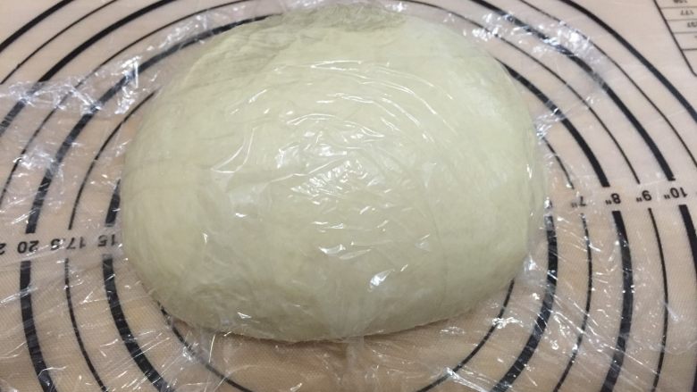 肉松海苔手撕面包 直接法,发酵后排气放在揉面垫上,盖保鲜膜松弛15分钟
