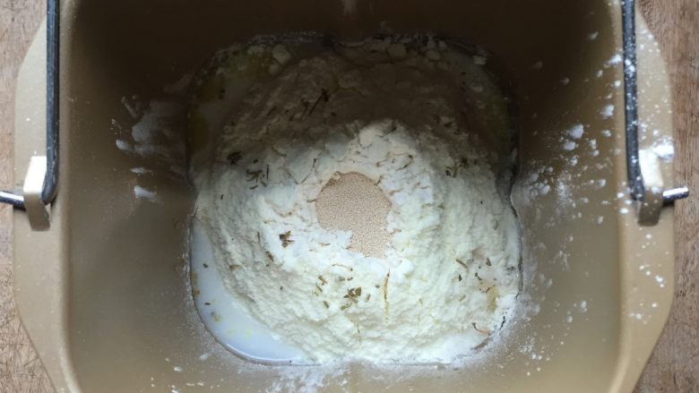 双酱培根披萨,面团的所有配料先液体后固体放入面包机桶内,糖、盐对角放,干酵母放面粉中间,启动和面程序,结束后启动发酵程序进行发酵;