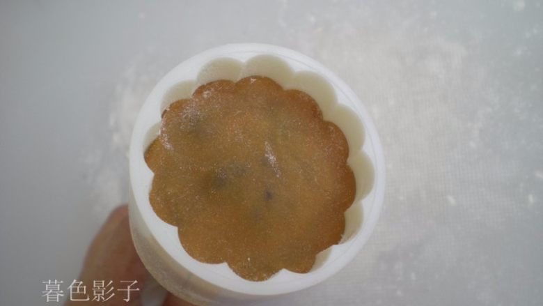 广式蛋黄月饼,放进模具里边,按压一下四边,这样边的花纹很清晰,底部一定有按平,不然月饼会偏。