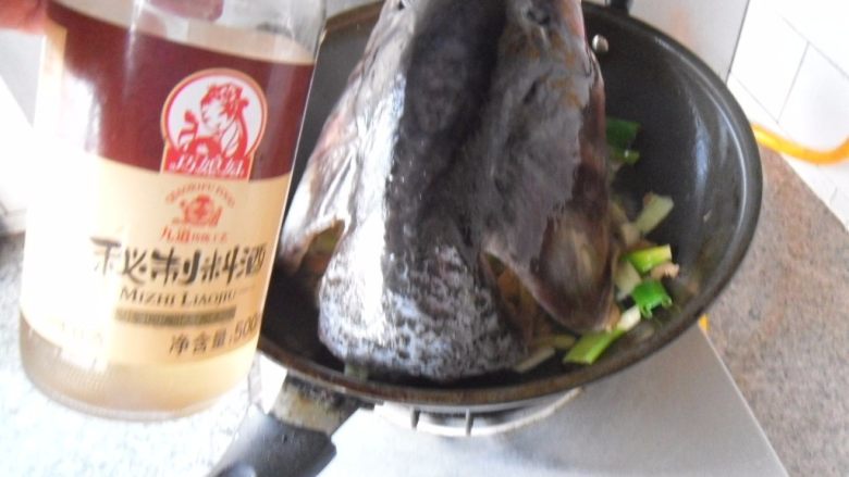炖大嘴鱼头,放入鱼头,旺火、烹入<a style='color:red;display:inline-block;' href='/shicai/ 718'>料酒</a>