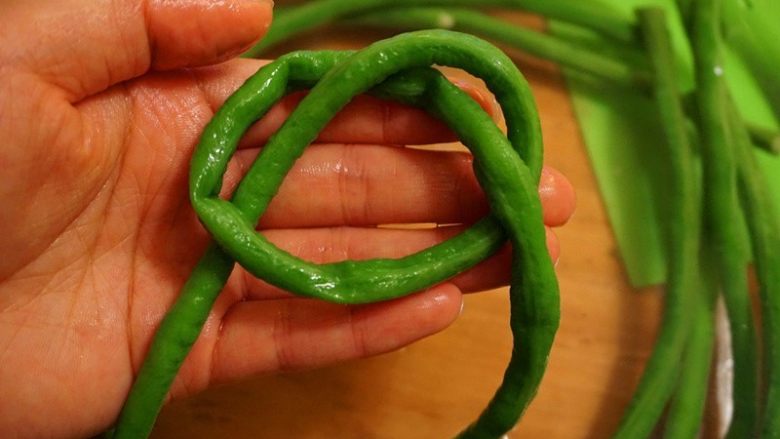 芝士肉末烤豇豆,8.豇豆从中间打一个活结(相信大家都会吧)