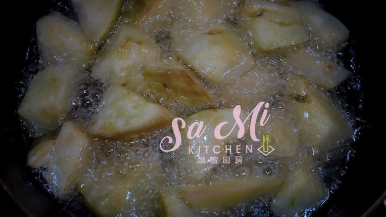 地三鲜(东北传统名菜),油锅中放入茄子块,炸软(用筷子轻轻戳茄子块,能戳透即可)关火捞出控油