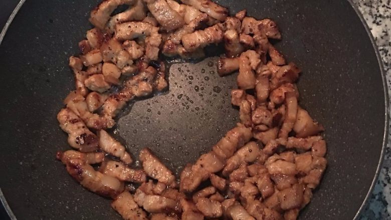 简易香菇油饭,炒出油且三层肉上色,将肉拨到周围,让中间;放入红葱头炒出香味后,再空出中间,开始炒其他的料。