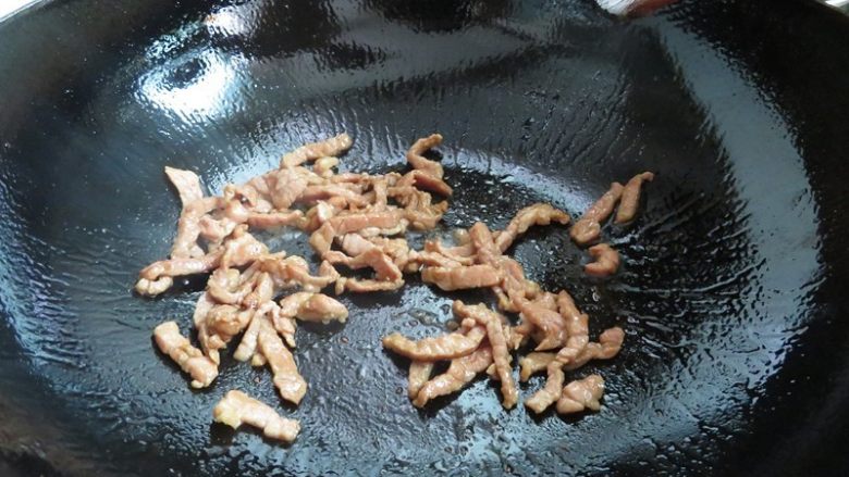 芹菜炒肉丝,锅中加油烧热后放入肉丝煸炒至变色断生