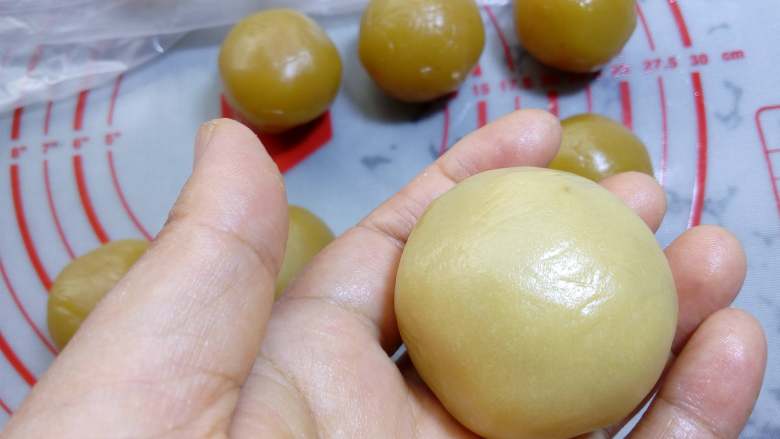 广式月饼~莲蓉蛋黄月饼,整理好收口,不能有缝隙,并搓圆。
