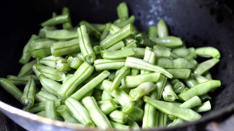 肉沫豆角焖面,将准备好的豆角放入油锅中翻炒，
