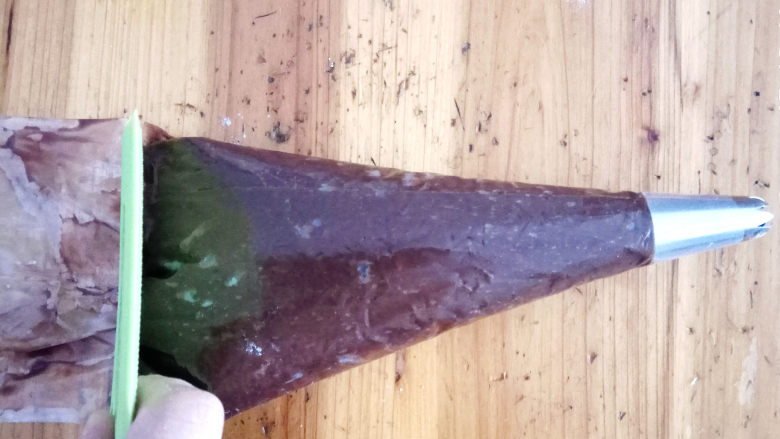 巧克力手指泡芙,准备一个裱花袋,装入六齿花嘴,将面糊倒入袋中。