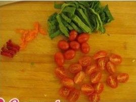 西式蛋饼,处理食材,菠菜叶子切成宽丝, <a style='color:red;display:inline-block;' href='/shicai/ 3440'>小西红柿</a>一份为二,彩椒切小块,培根也切小块。