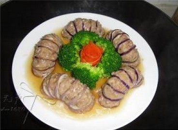 肉酿茄龙,将汤汁浇在茄夹上，中间放上西兰花，还有刨出的胡萝卜花即可