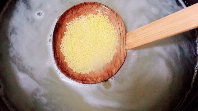 牛奶番薯粥,砂锅中烧开水,下入小米熬煮。