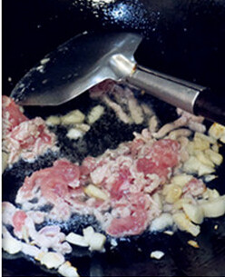 鲜辣小炒茶树菇,热锅冷油，入蒜碎炒香，将肉丝煸炒片刻