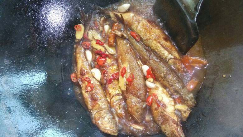 香焖河鱼,把调料下锅煸香后下鱼放料洒，<a style='color:red;display:inline-block;' href='/shicai/ 788'>生抽</a>、<a style='color:red;display:inline-block;' href='/shicai/ 4510'>黄豆酱</a>和水漫过鱼面，加盖焖至收汁