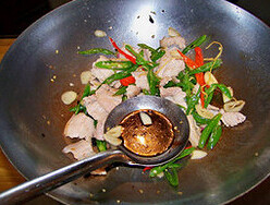 农家小炒肉,下五花肉片,淋生抽、老抽、蒸鱼豉油,翻炒均匀