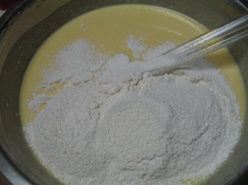 大理石乳酪蛋糕,加入黄油拌均,分次加入蛋黄,搅拌均匀,筛入粉类