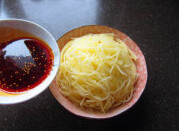 炝拌土豆丝 ,土豆丝装盘,上桌前浇上调味汁,拌匀即可