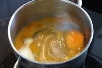 有Scrambled Egg的营养早餐,炉子热了以后,把奶锅放在炉子上,现在开始快速搅拌鸡蛋。
