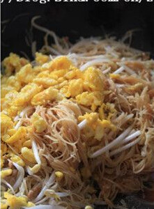 黄金炒米面,倒入酱油,米面,绿豆芽和鸡蛋翻炒