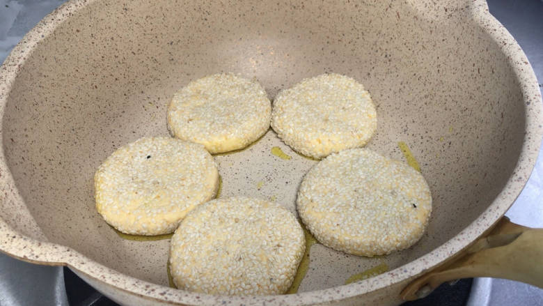 田园南瓜饼,放入热油锅中,中火慢煎,煎至底部变色,翻面