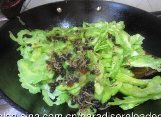 豆豉小鱼炒苦瓜,蒜瓣切片。油锅里爆香蒜片，下苦瓜翻炒，起锅之前加入点豆豉小鱼酱炒匀