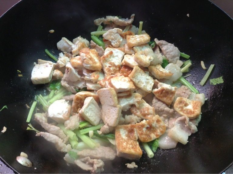 芹香豆腐,如图再放入煎好的豆腐加盐炒均匀即可