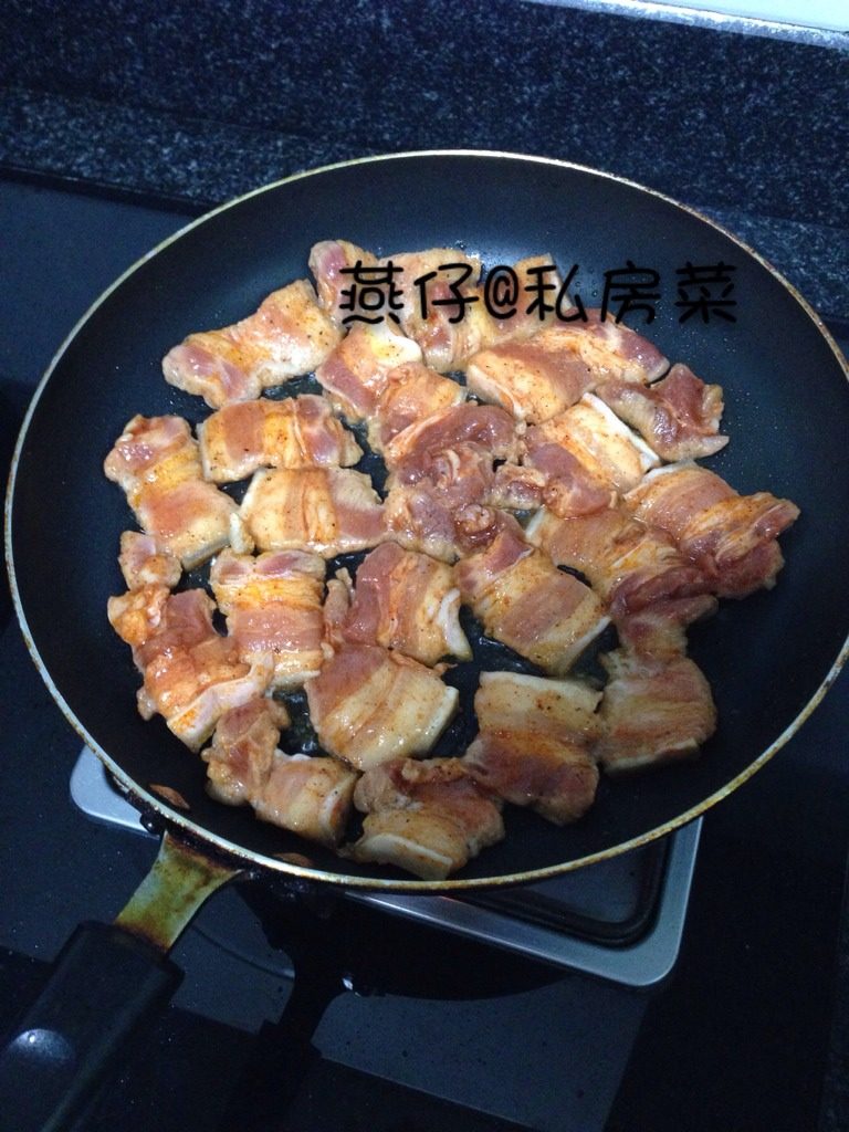 香煎五花肉,如图平底锅面上，涮上一层油，放入五花肉煎至里面微焦即可。