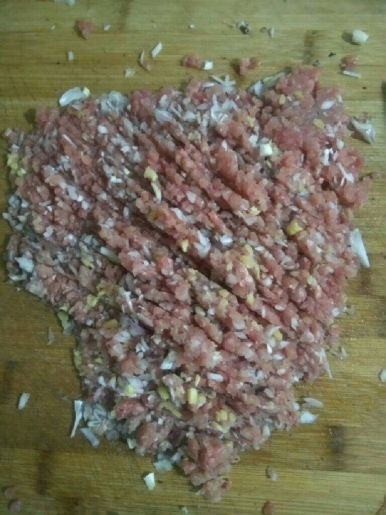 猪肉香菇水饺,把猪肉切成饺子陷,切的时候把葱和姜和肉一起切碎